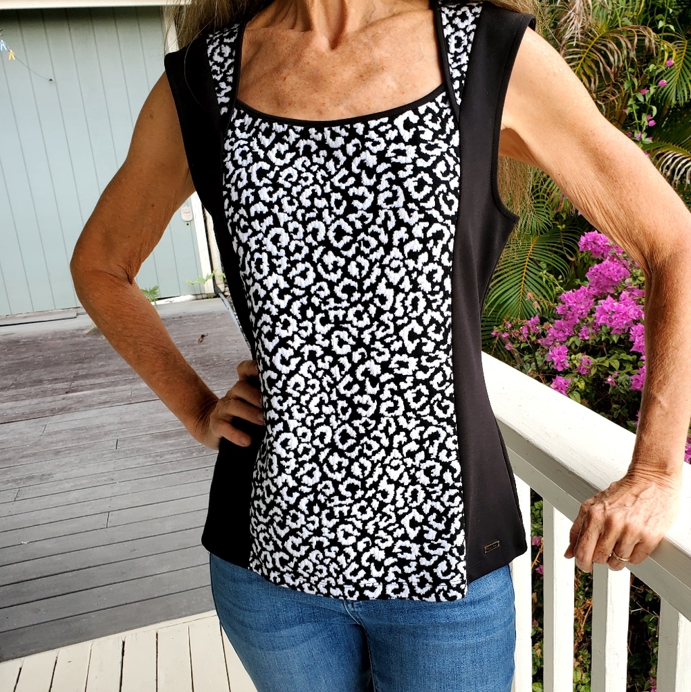 Calvin Klein top. True size is closer to Medium but labeled Petite.  Worn once!